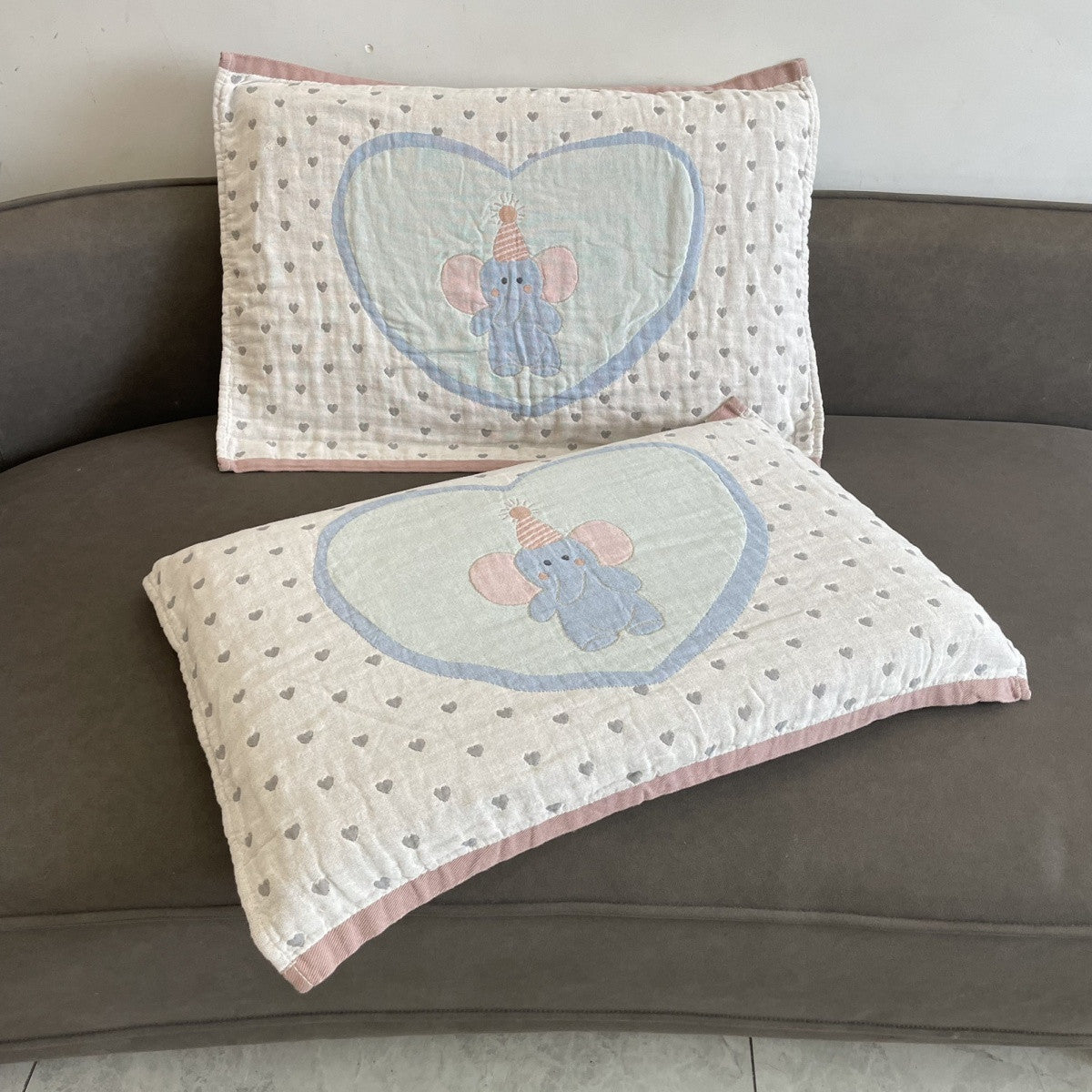 Elephant and heart pillow towels with pale blue hearts and pink edging.