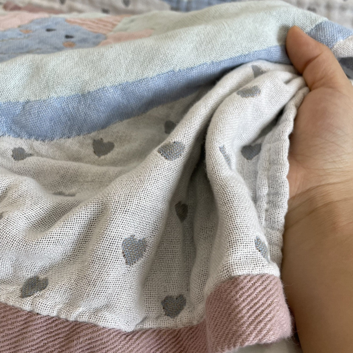 Close-up of gauze weave, small hearts and pink edging.