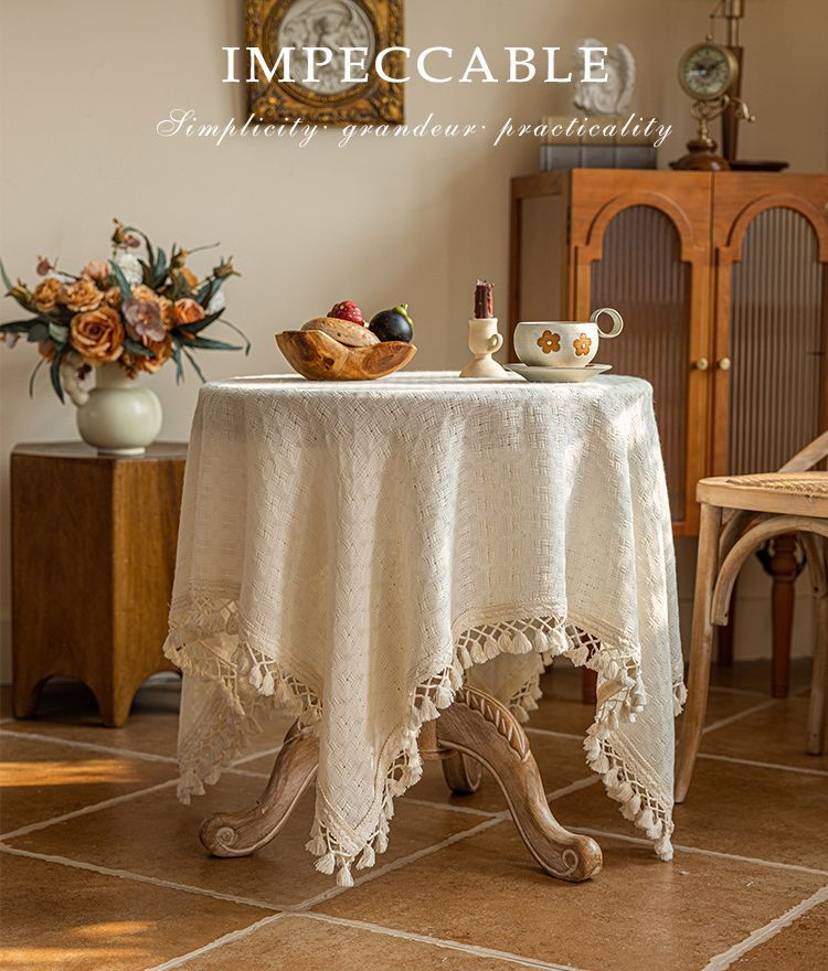 Close-up of the woven beige tablecloth and tassel fringe