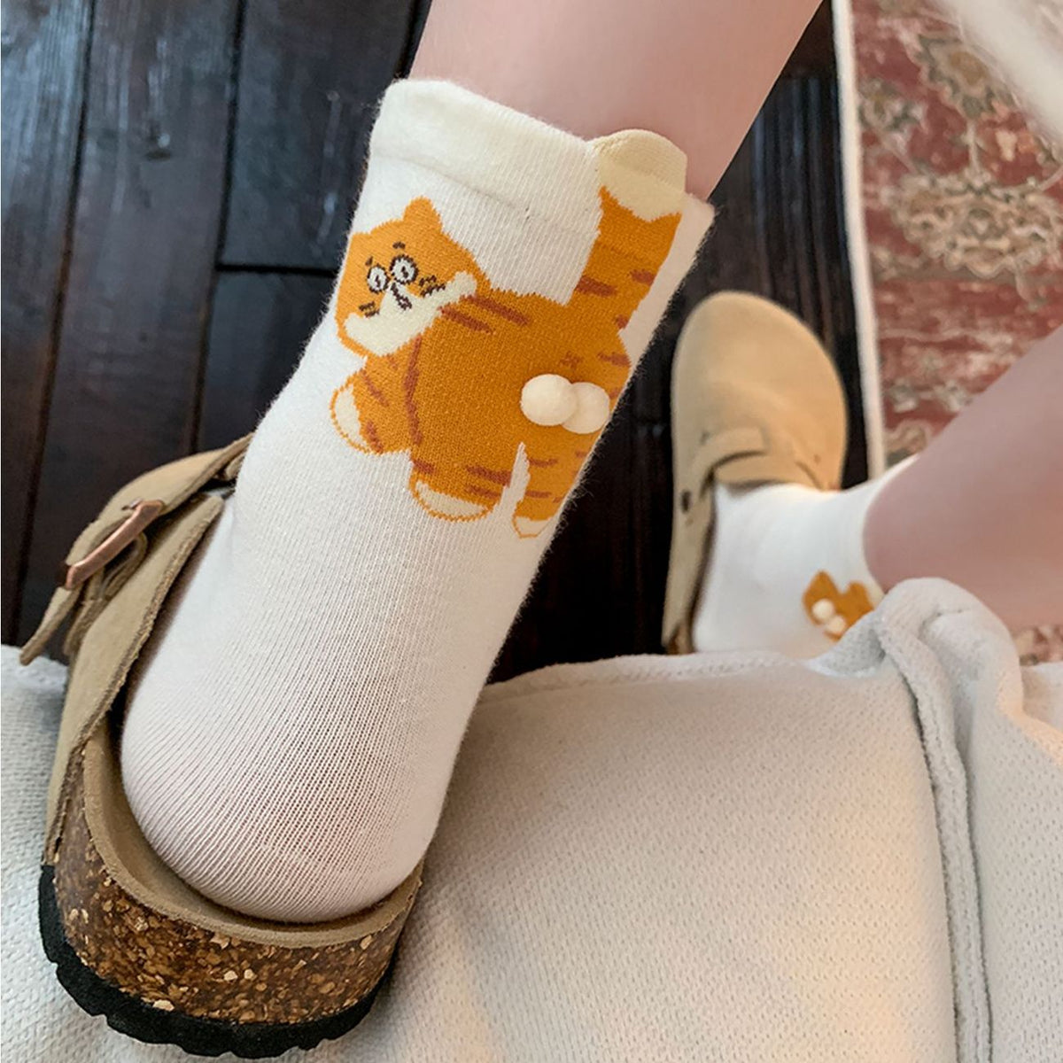 Cute cat crew socks with orange cat detail worn on foot