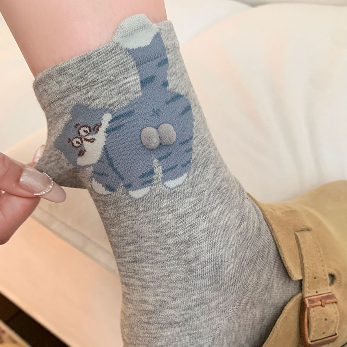 Grey crew socks with blue cartoon cat pattern