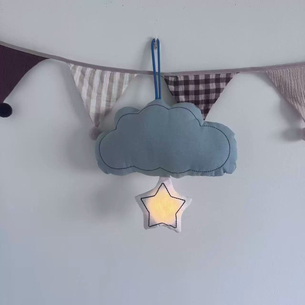 Blue hanging cloud night light with illuminated star