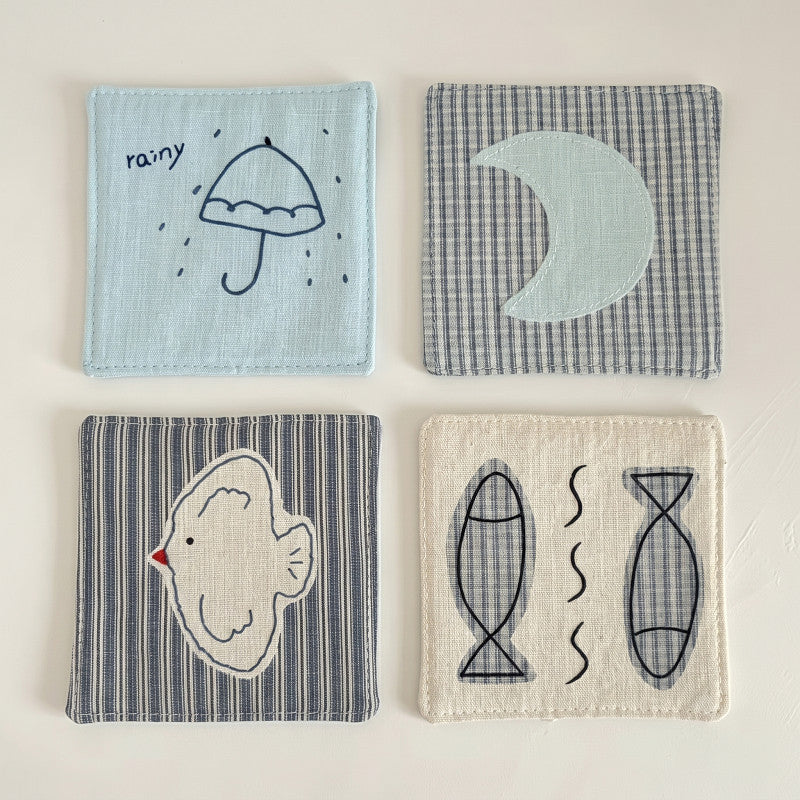 Four square cotton-linen coasters shown together: umbrella, moon, bird and fish designs.