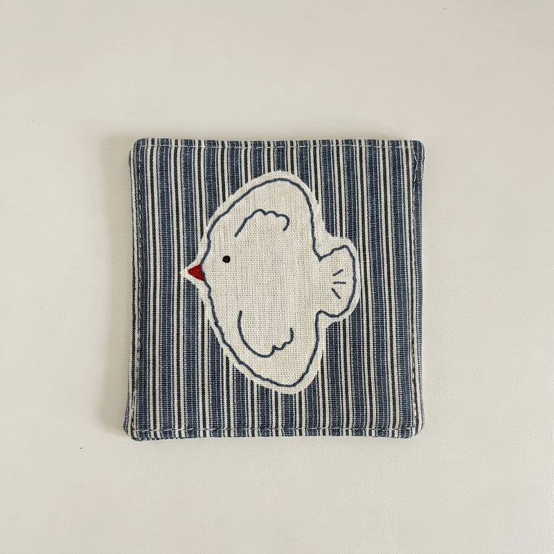 Striped cotton-linen coaster with an embroidered bird design.