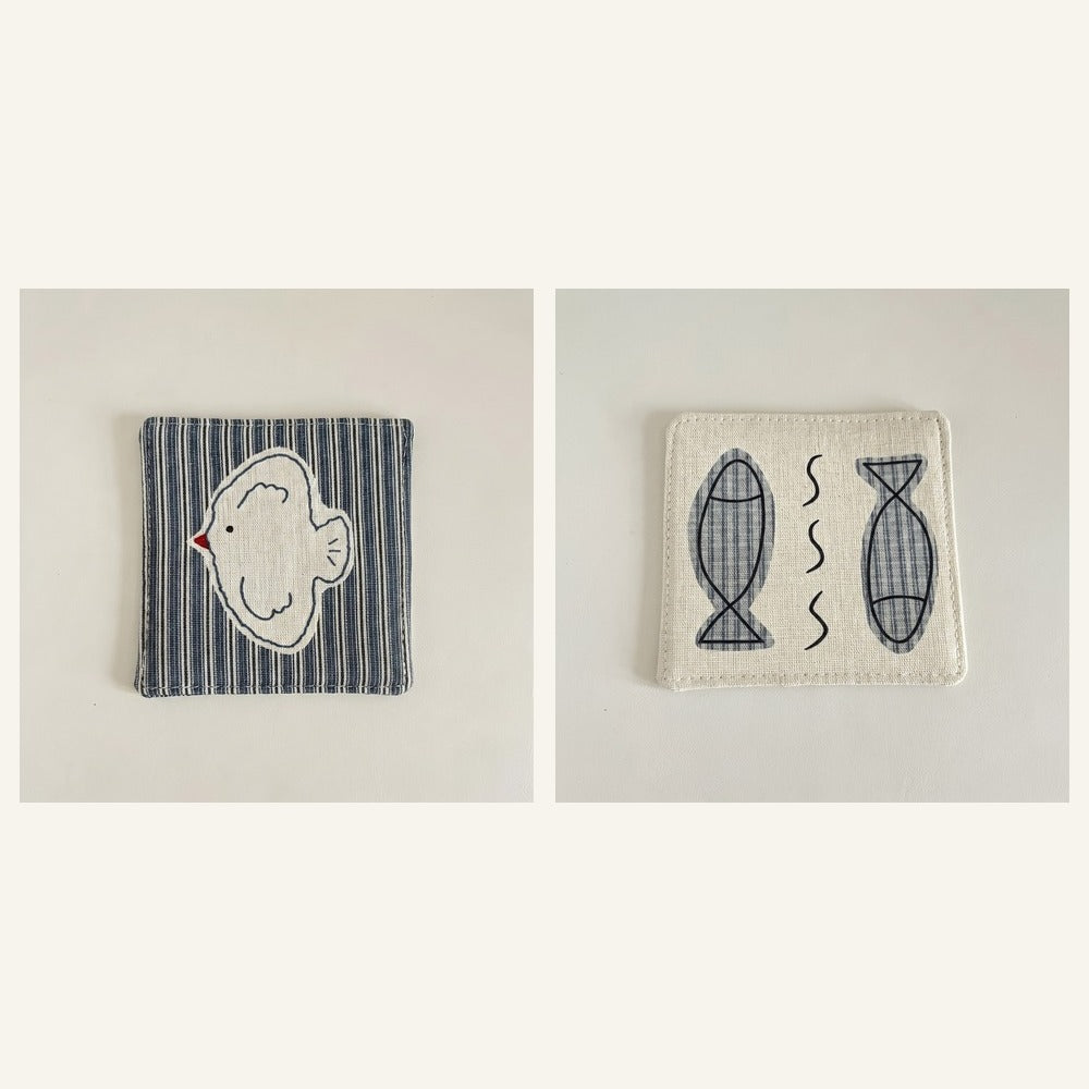 Cotton-linen fabric coaster set showing bird and fish designs.
