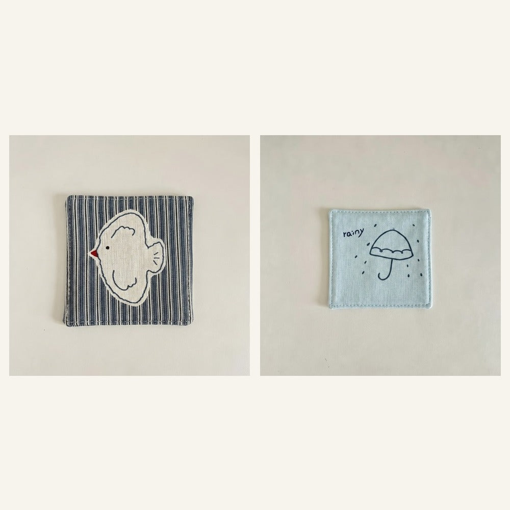 Cotton-linen fabric coaster set showing bird and rain designs.
