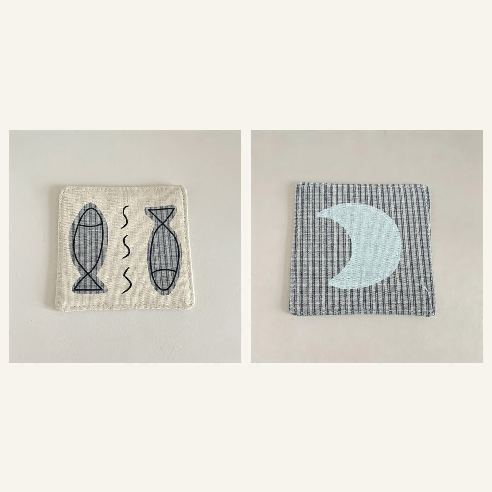 Cotton-linen fabric coaster set showing fish and moon designs.