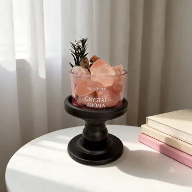 Pink crystal diffuser bowl on a dark pedestal base