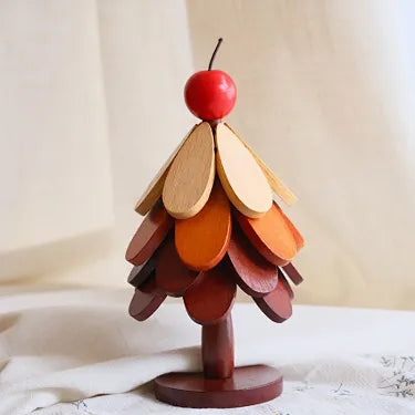 Apple topper four layer wooden Christmas tree trivet on a table