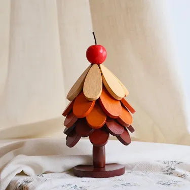 Apple topper five layer wooden Christmas tree trivet on a table
