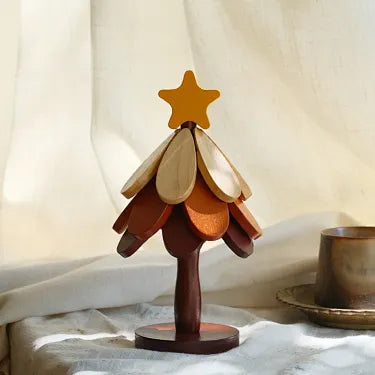 Star topper three layer wooden Christmas tree trivet on a table