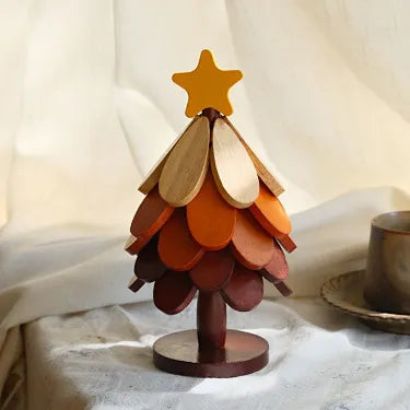 Star topper five layer wooden Christmas tree trivet on a table