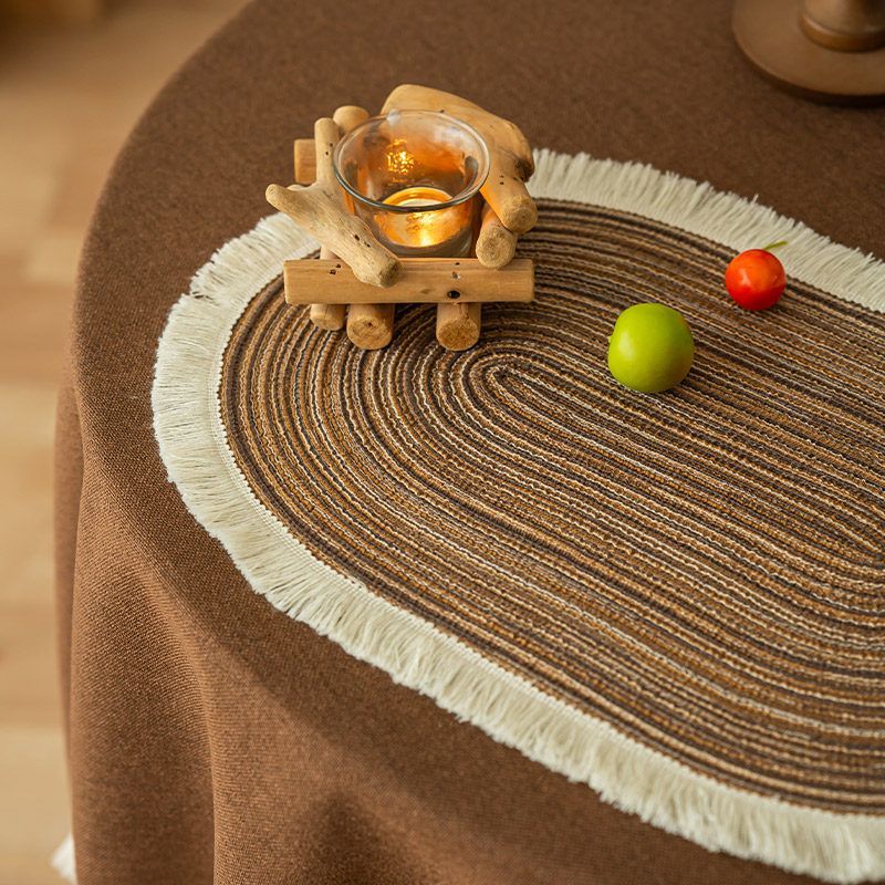 Beige oval placemat with cream fringe