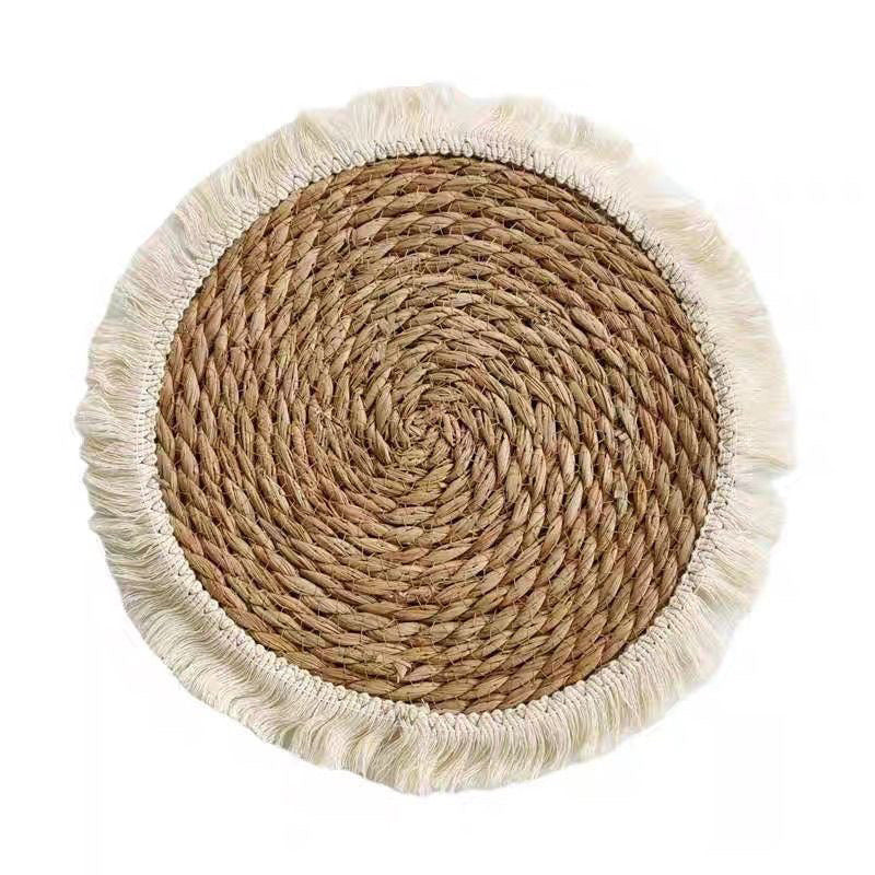 Close view of circular straw weave and cream fringe