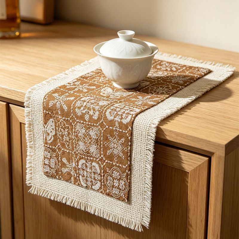 Brown patterned tea mat with fringed cotton-linen base
